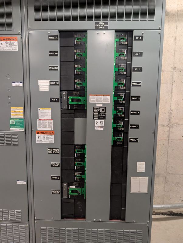 Main switchboard with labelled feeder breakers in a mechanical electrical room.
