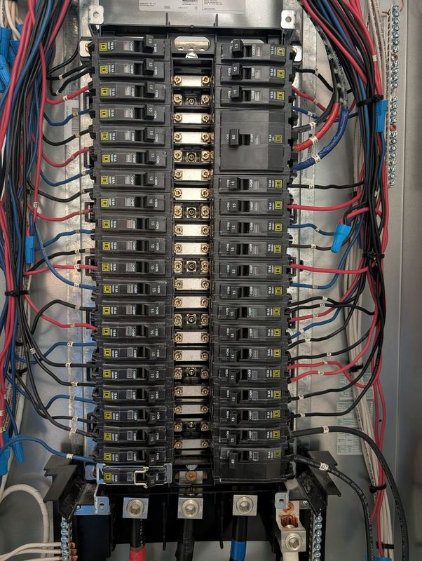 Panelboard interior with neatly dressed branch circuit wiring.