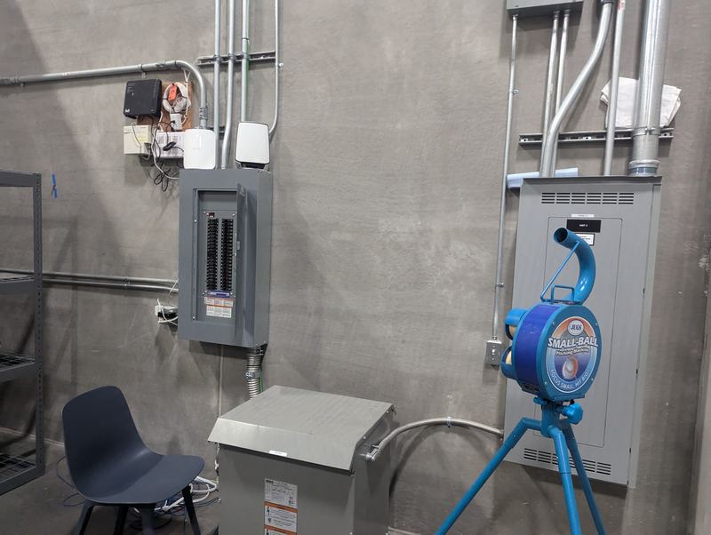 Commercial electrical room with panelboards, a dry-type transformer and conduit runs