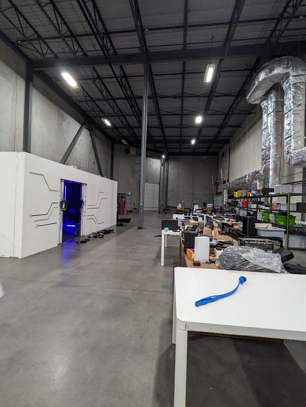 Large commercial unit with an open steel roof structure lit by LED high-bay fixtures