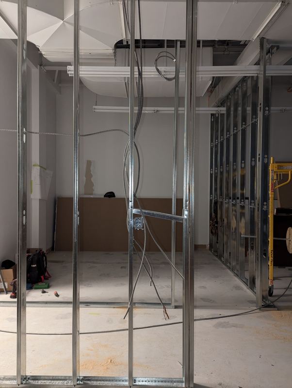 Commercial interior with steel-stud partitions and electrical cabling dropped in before drywall
