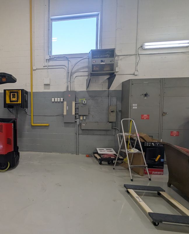 Warehouse wall with a forklift battery charger, disconnects, distribution equipment and conduit